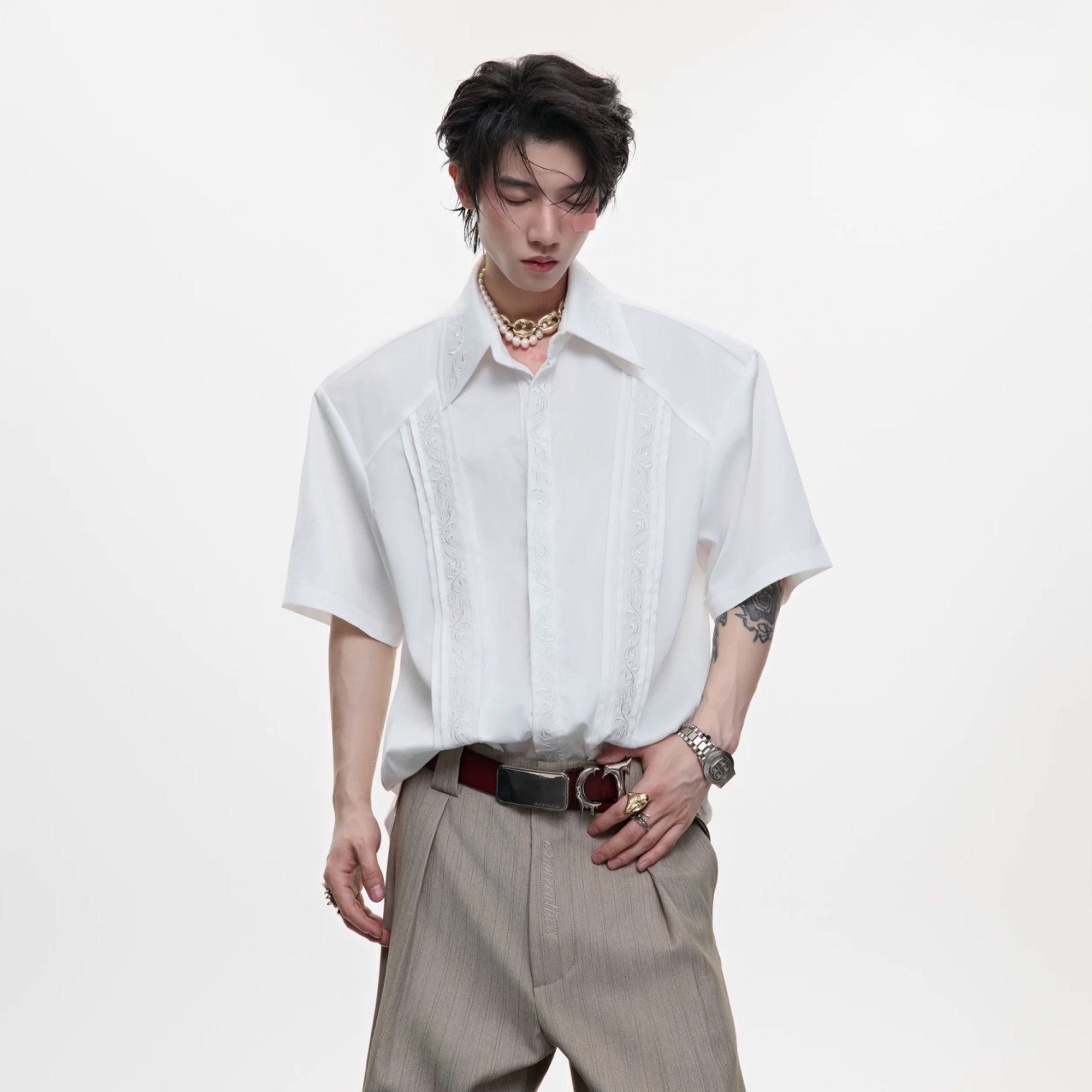 Front view of white vintage embroidered streetwear shirt with shoulder pads