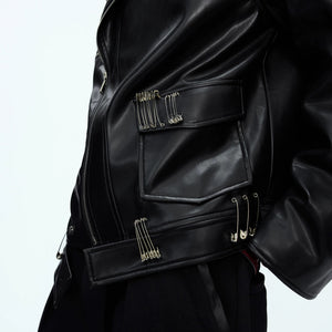 Close up of metal pin accents and deconstructed zipper details