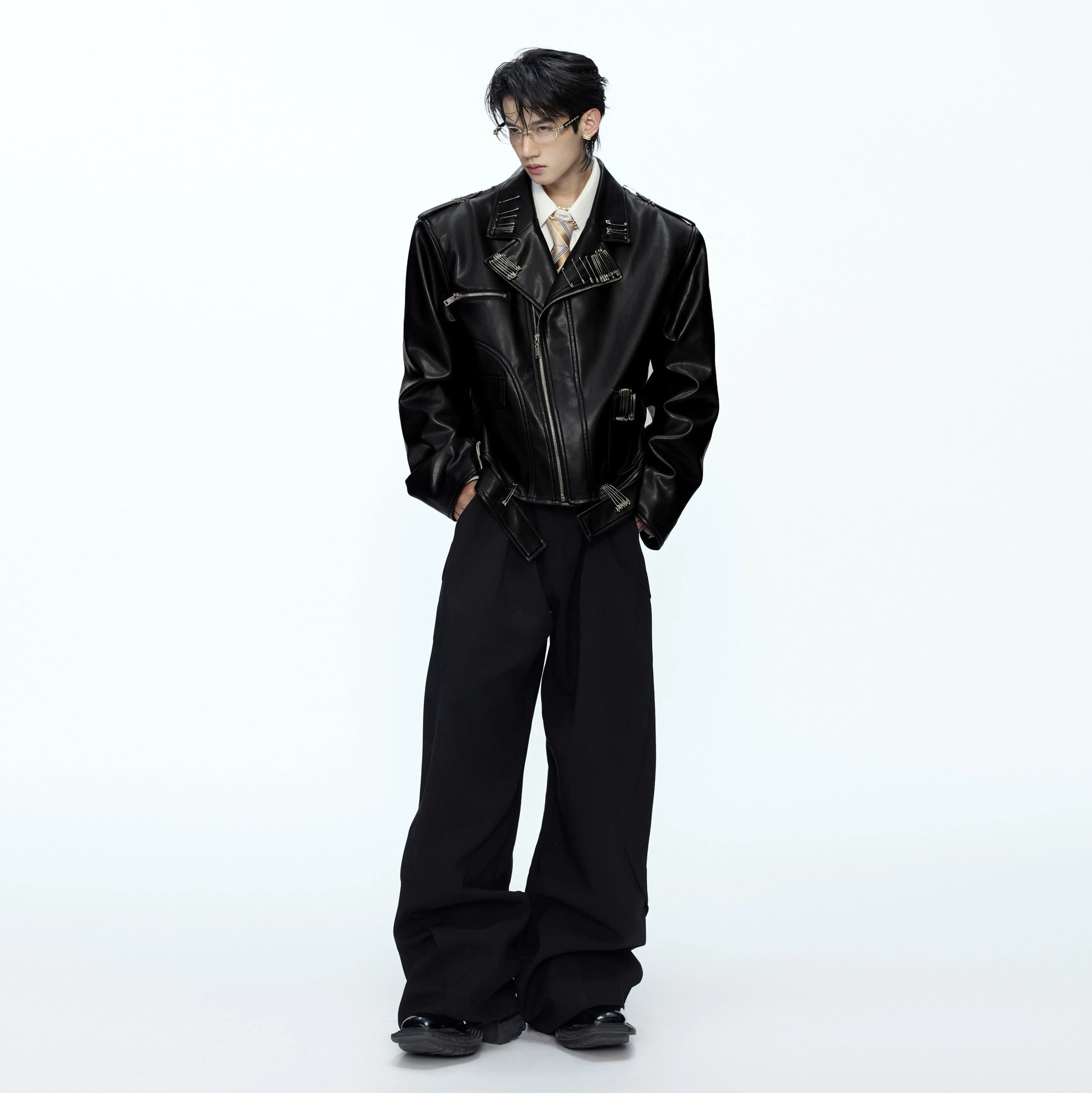 Model wearing a cropped boxy leather jacket in a streetwear setting