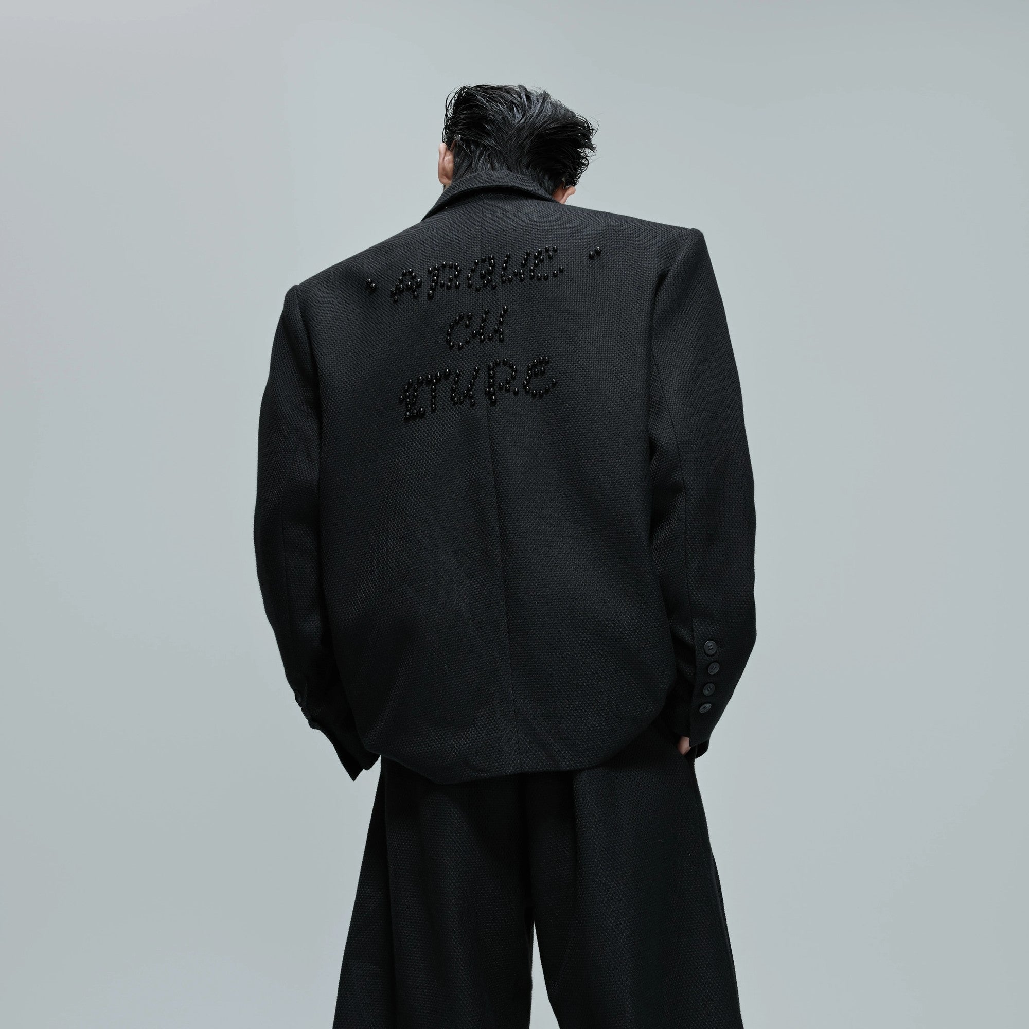 Back view of the oversized blazer showing the back vent design