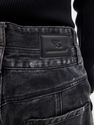 Streetwear model wearing wide-leg distressed jeans and sneakers