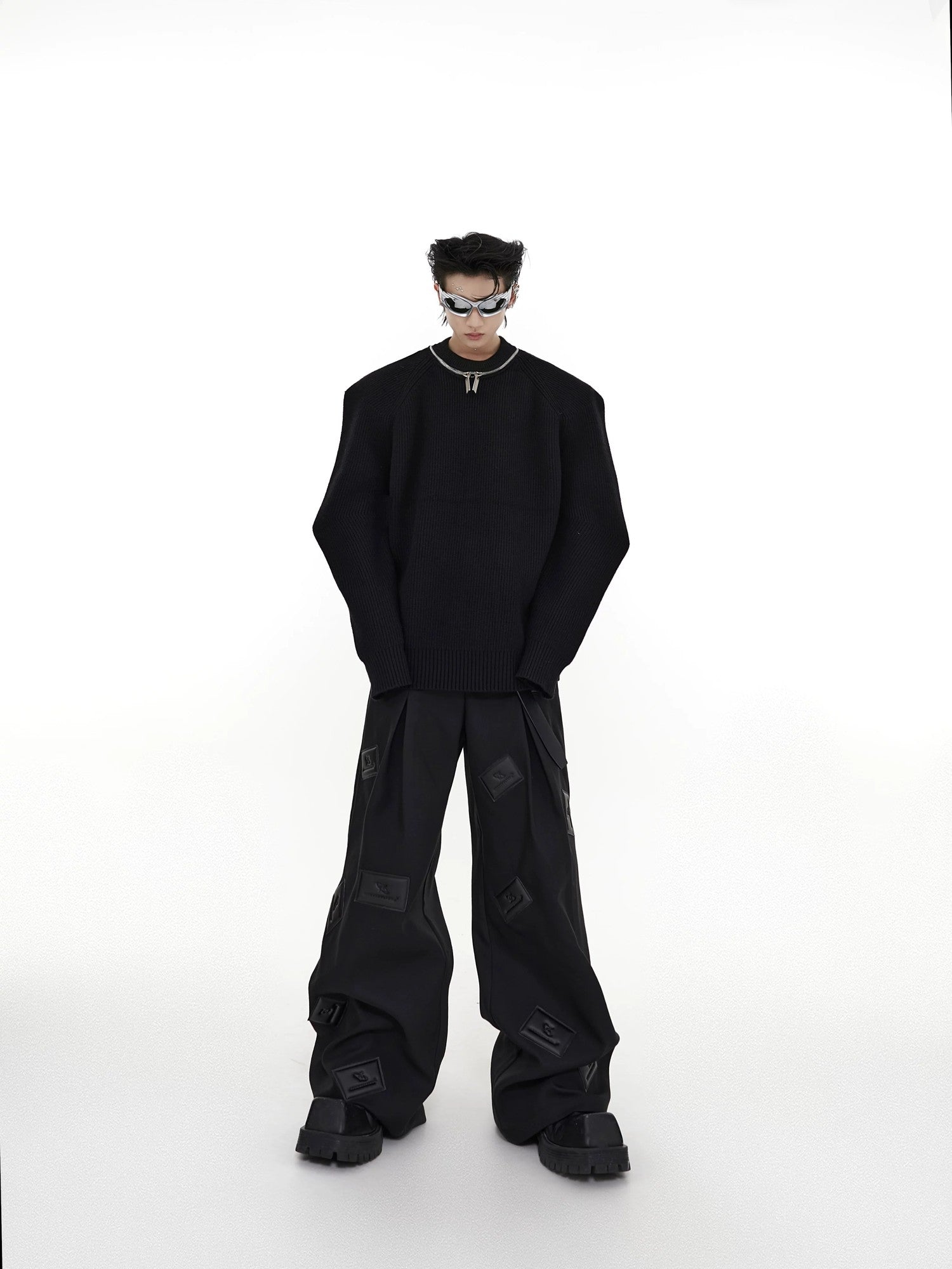 Back view of the loose fit silhouette of the 3D leather patch pants